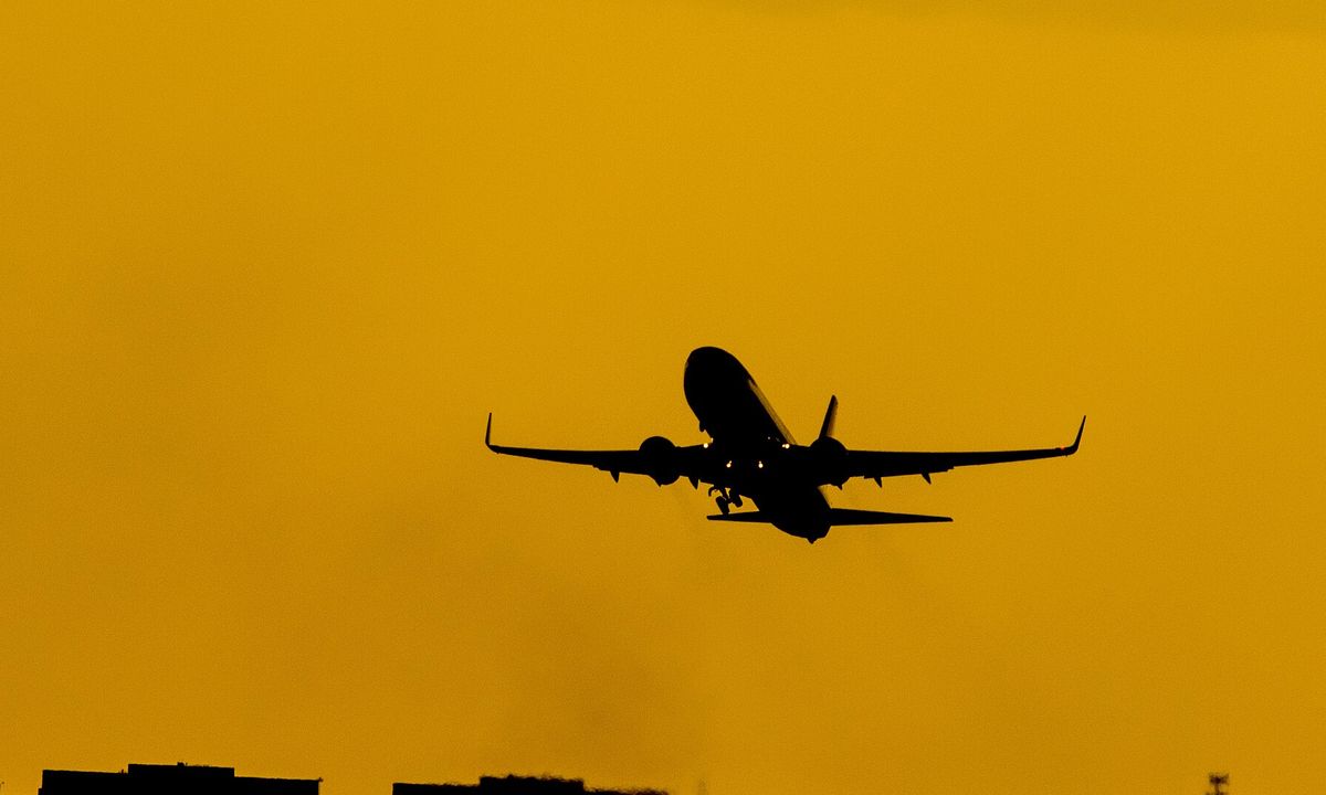 A passenger aircraft climbing into a blue sky